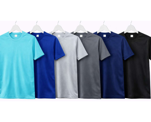 Assorted color t-shirts on white hangers displayed in a row (turquoise, blue, gray, navy, black). -
