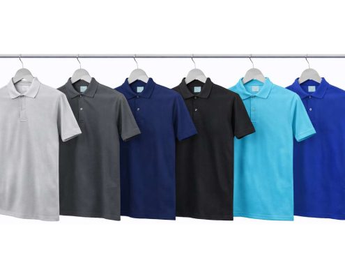 Row of polo shirts in gradient colors hanging on a clothing rack from left to right (gray to blue). -