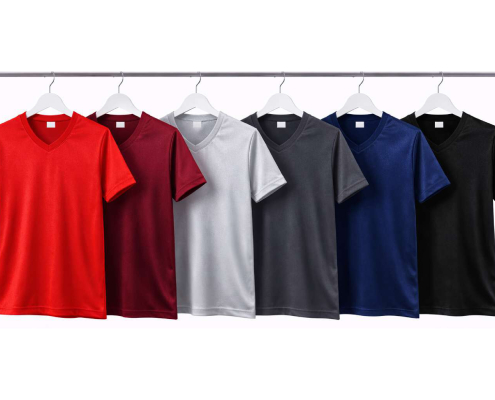 DRY TOUCH V YAKA YAĞMUR DESEN FORMA 1_page-0002 - Fatih iş elbiseleri istanbul Row of seven colored V-neck T-shirts on white hangers hanging from a metal rod, left to right: red, burgundy, light gray, gray, navy, royal blue, black. -