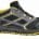Trail running shoe with black mesh, gray overlays, and yellow accents; rugged yellow sole for traction. -