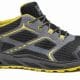 Trail running shoe with black mesh, gray overlays, and yellow accents; rugged yellow sole for traction. -