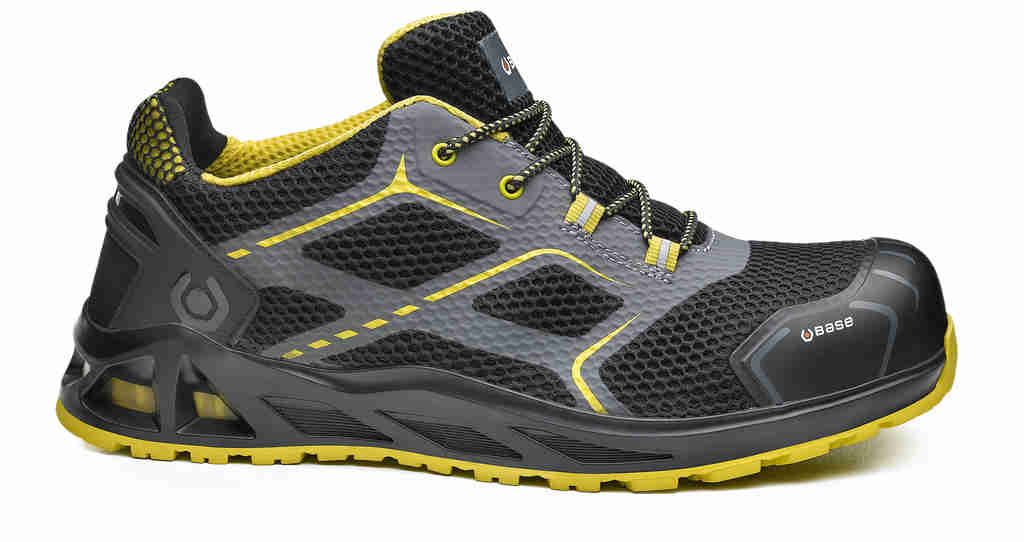 Trail running shoe with black mesh, gray overlays, and yellow accents; rugged yellow sole for traction. -
