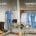 Split shop display: left side shows work boots and safety gear; right side features medical scrubs and uniforms on racks. -